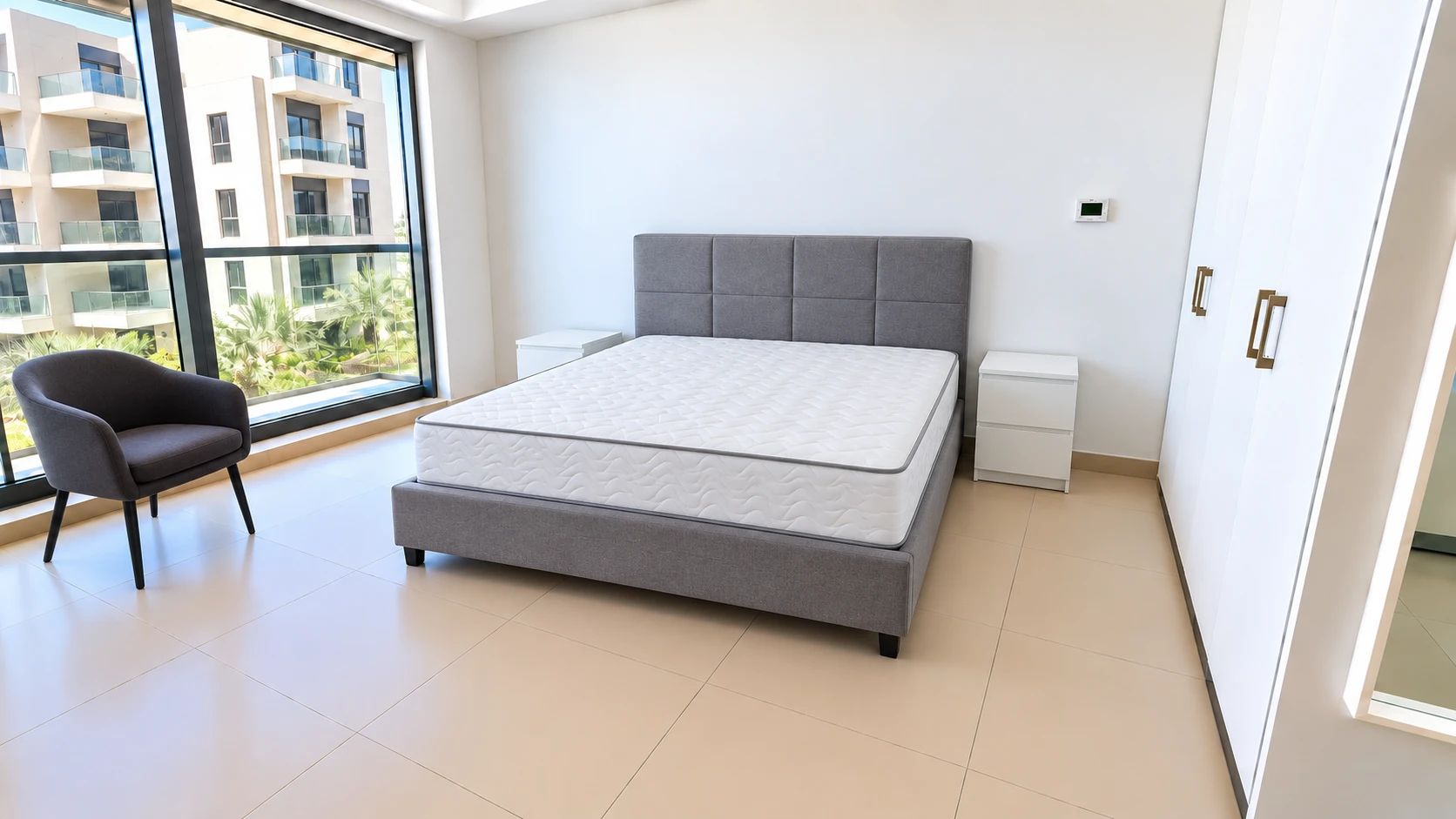 A bedroom furnished with this package: upholstered bed, bedside tables, an armchair by the window.